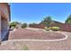 Exterior of house with gravel and raised garden beds in backyard at 44092 W Stonecreek Rd, Maricopa, AZ 85139