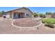 Exterior of house with gravel and raised garden beds in backyard at 44092 W Stonecreek Rd, Maricopa, AZ 85139