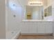 Bathroom featuring double sinks, white cabinets, and a walk-in shower at 44092 W Stonecreek Rd, Maricopa, AZ 85139