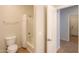 Bright bathroom featuring a toilet, a tub/shower combo with white tile surround, and a tile floor at 44092 W Stonecreek Rd, Maricopa, AZ 85139