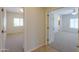 View of carpeted bedrooms with neutral walls showcasing natural light, and a view of an open doorway at 44092 W Stonecreek Rd, Maricopa, AZ 85139