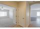 Carpeted room featuring an open doorway and views into the adjacent bedrooms and main living areas at 44092 W Stonecreek Rd, Maricopa, AZ 85139