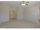 Bedroom featuring carpet flooring, ceiling fan, neutral walls, and doorways leading to other rooms at 44092 W Stonecreek Rd, Maricopa, AZ 85139