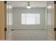 Bedroom featuring neutral walls, carpet flooring, a ceiling fan and a large window at 44092 W Stonecreek Rd, Maricopa, AZ 85139