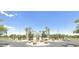 Community entrance with beautiful landscaping and stone accents at 44092 W Stonecreek Rd, Maricopa, AZ 85139