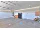 Spacious garage with a refrigerator, water heater, and concrete flooring at 44092 W Stonecreek Rd, Maricopa, AZ 85139