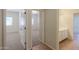 Hallway leading to a bedroom and bathroom with tile flooring at 44092 W Stonecreek Rd, Maricopa, AZ 85139