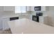 Modern kitchen featuring white cabinets, quartz countertops, stainless steel appliances, and a large island at 44092 W Stonecreek Rd, Maricopa, AZ 85139