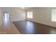 Spacious living room featuring tile and wood flooring with lots of light at 44092 W Stonecreek Rd, Maricopa, AZ 85139