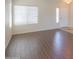 An empty living room with hard surface floors at 44092 W Stonecreek Rd, Maricopa, AZ 85139