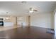 Open concept living room with wood floors and access to the kitchen at 44092 W Stonecreek Rd, Maricopa, AZ 85139