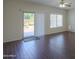 Living room featuring wood floors, a ceiling fan and sliding glass door to backyard at 44092 W Stonecreek Rd, Maricopa, AZ 85139