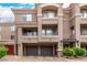 Inviting townhome exterior with a two-car garage and balcony railings at 4455 E Paradise Village S Pkwy # 1057, Phoenix, AZ 85032