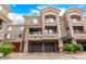 Townhome with two-car garage, decorative balcony railings, and lush landscaping at 4455 E Paradise Village S Pkwy # 1057, Phoenix, AZ 85032