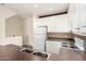 Functional kitchen layout with white appliances and convenient counter seating at 4455 E Paradise Village S Pkwy # 1057, Phoenix, AZ 85032