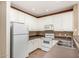 Efficient kitchen featuring white appliances, ample counter space, and tile flooring at 4455 E Paradise Village S Pkwy # 1057, Phoenix, AZ 85032