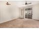 Cozy living room with carpet, ceiling fan, and access to the balcony at 4455 E Paradise Village S Pkwy # 1057, Phoenix, AZ 85032