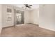Bright, open living room with balcony access, carpet, and ceiling fan at 4455 E Paradise Village S Pkwy # 1057, Phoenix, AZ 85032