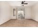 Neutral living room with carpet, ceiling fan, and sliding doors to the balcony at 4455 E Paradise Village S Pkwy # 1057, Phoenix, AZ 85032