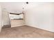 Open living room with carpet and view into the kitchen area at 4455 E Paradise Village S Pkwy # 1057, Phoenix, AZ 85032