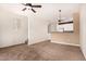 Open living room with carpet and view into the kitchen area at 4455 E Paradise Village S Pkwy # 1057, Phoenix, AZ 85032