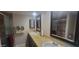 Bathroom with double sinks, decorative mirrors, granite countertops, and walk-in shower at 4733 W Eva St, Glendale, AZ 85302