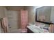 Bathroom with pink décor, including a shower curtain and decorative toiletries at 4733 W Eva St, Glendale, AZ 85302