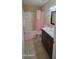 Charming bathroom with colorful accents, pink toilet and vanity sink combo at 4733 W Eva St, Glendale, AZ 85302