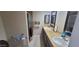Bright bathroom featuring dual sinks, granite countertops, and a large mirror at 4733 W Eva St, Glendale, AZ 85302