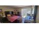 Bedroom with dark wood furniture, including bed, nightstands, dresser, and large window at 4733 W Eva St, Glendale, AZ 85302