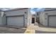 Charming townhome exterior with attached garages and desert landscaping at 4733 W Eva St, Glendale, AZ 85302