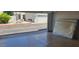 View of a spacious two car garage with epoxy floors and a glimpse of the neighborhood at 4733 W Eva St, Glendale, AZ 85302