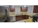 Kitchen features stainless steel appliances, dark wood cabinets and light countertops at 4733 W Eva St, Glendale, AZ 85302