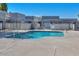 Community pool surrounded by black metal fencing and clear, blue water at 4733 W Eva St, Glendale, AZ 85302
