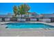 Community pool with clear blue water and surrounding patio area at 4733 W Eva St, Glendale, AZ 85302