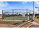 Outdoor tennis court enclosed with chain-link fencing and lighting, for community use at 4733 W Eva St, Glendale, AZ 85302