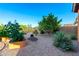 The backyard features desert landscaping, gravel beds, garden boxes and patio at 47719 N Camino Del Sol --, Gold Canyon, AZ 85118