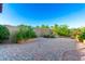 Spacious backyard featuring a brick patio, desert landscaping, raised garden beds, and a privacy wall at 47719 N Camino Del Sol --, Gold Canyon, AZ 85118