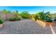 Backyard view showcases a brick patio, desert landscaping, and raised garden beds surrounded by a block wall at 47719 N Camino Del Sol --, Gold Canyon, AZ 85118