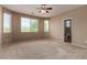 Cozy bedroom featuring plush carpeting, a ceiling fan, and a bright window at 47719 N Camino Del Sol --, Gold Canyon, AZ 85118