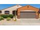 Attractive single-story home with stone accents, desert landscaping, and a two-car garage at 47719 N Camino Del Sol --, Gold Canyon, AZ 85118
