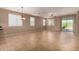 Bright and airy living room with neutral tones, tile flooring, and sliding glass door access at 47719 N Camino Del Sol --, Gold Canyon, AZ 85118