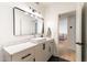 Elegant bathroom with a modern vanity, vessel sink, and stylish fixtures leading into an open doorway to the house at 5505 E Mclellan Rd # 111, Mesa, AZ 85205