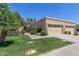 Tan exterior elevation with lush green lawn and desert landscaping at 5505 E Mclellan Rd # 111, Mesa, AZ 85205