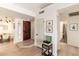 Inviting foyer features wood floors, a dark wood door, and access to dining and bath at 5505 E Mclellan Rd # 111, Mesa, AZ 85205