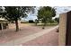 Community front yard featuring decorative gravel, sidewalk, and mature trees at 5505 E Mclellan Rd # 111, Mesa, AZ 85205