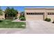 Attached beige garage with two bays and a well-manicured green lawn at 5505 E Mclellan Rd # 111, Mesa, AZ 85205