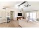 Bright living room with vaulted ceilings, wood beams, and sliding door access to outdoor area at 5505 E Mclellan Rd # 111, Mesa, AZ 85205