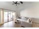 Spacious living room with an oversized white sofa and sliding glass doors to patio at 5505 E Mclellan Rd # 111, Mesa, AZ 85205