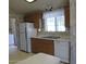 Efficient kitchen with a window above the double basin sink and a white refrigerator at 5808 E Lockwood St, Mesa, AZ 85215